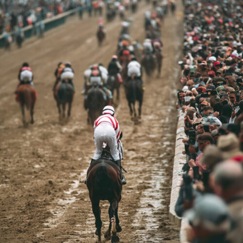 Exciting horse racing action at the hippodrome with jockeys in full gallop from a vantage point